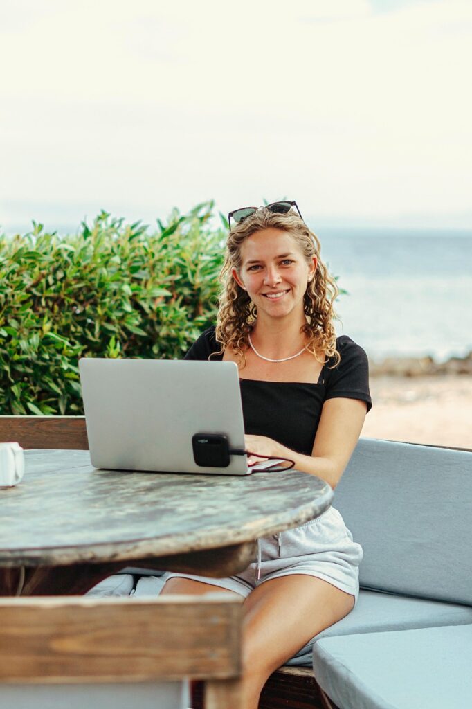 digital nomad, work online, cowork, laptop, nature, macbook, beach, sea, work, workplace, location independent, sun, call, zoom, meeting, online meeting, webinar, video conference, online, teams, hands, pretty, woman Freelancing in Video Editing