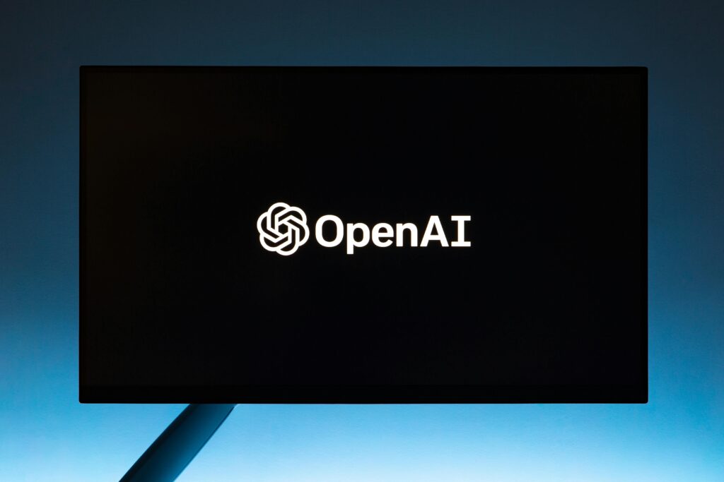 Digital Marketing Course in Varanasi Minimalist display of OpenAI logo on a screen, set against a gradient blue background.
