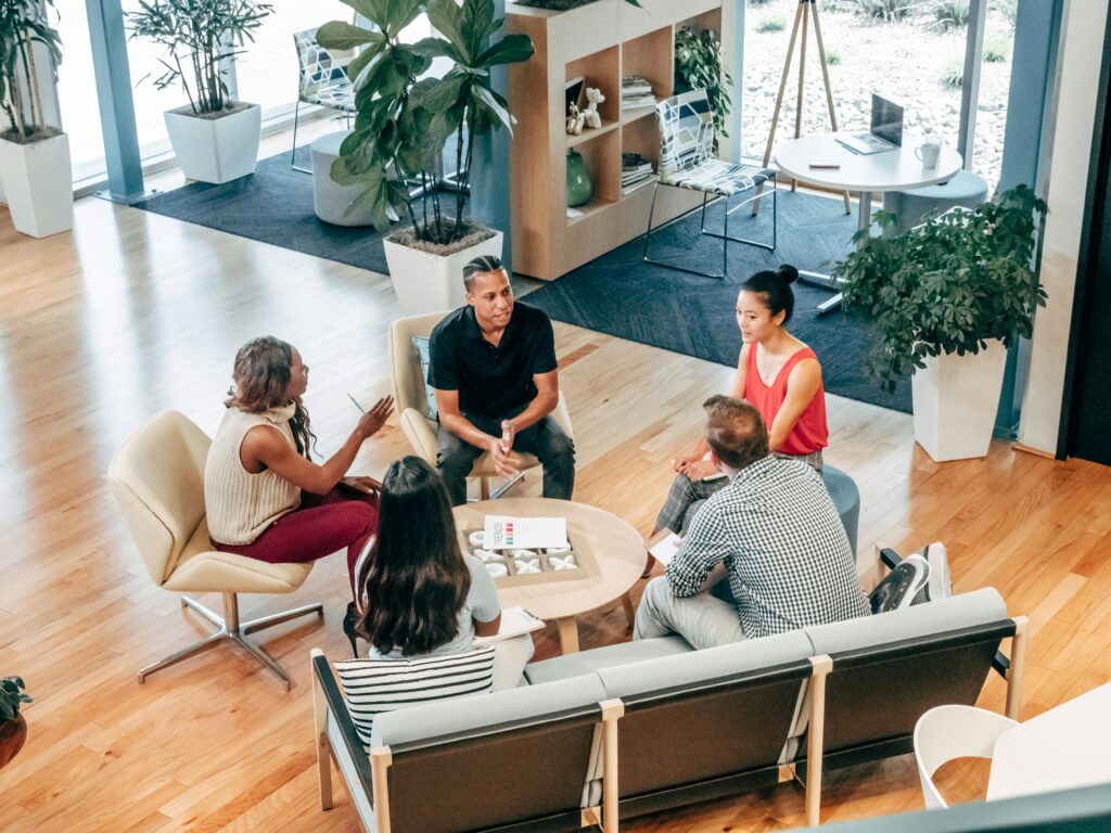Digital Marketing Course in Varanasi A diverse group of professionals engage in a collaborative team meeting in a stylish office environment.